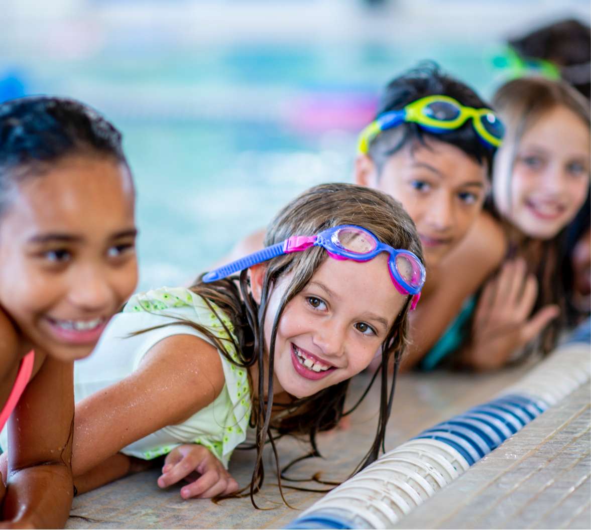 Kids lined up at edge of pool